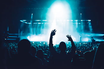 High-energy live music concert with crowd and vibrant stage lighting creating a dramatic atmosphere. HD wallpaper
