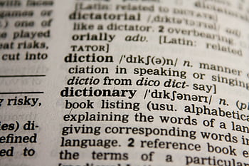Detailed close-up view of a dictionary page highlighting the word 'dictionary' and its definition. HD wallpaper