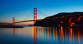 Golden Gate Bridge reflecting in the water during sunset in San Francisco. Iconic architectural landmark. HD wallpaper