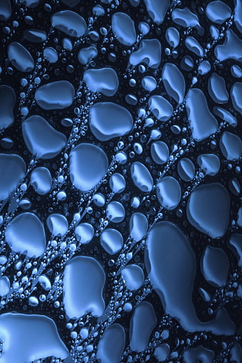 Abstract close-up of water droplets on a textured blue surface, creating a vibrant pattern. HD phone wallpaper