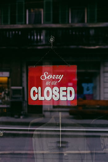 Red 'Sorry We Are Closed' sign displayed in a shop window indicating closure. HD phone wallpaper