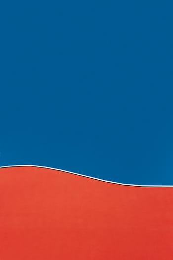A vibrant abstract design featuring a bold red curve against a deep blue background, showcasing minimalist style. HD phone wallpaper
