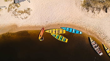 Aerial shot of vibrant boats on a sandy beach in Baía Formosa, Brazil. HD wallpaper