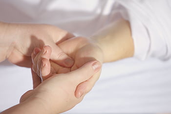 Relaxing hand massage therapy session close-up with gentle touch and care. HD wallpaper