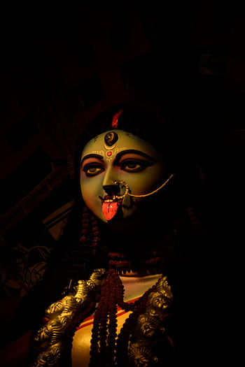 A striking statue of Goddess Kali with vivid colors and traditional adornments in Kolkata. HD phone wallpaper