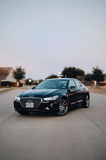 Luxury black sedan with shining headlights parked on a suburban road during daytime. HD phone wallpaper