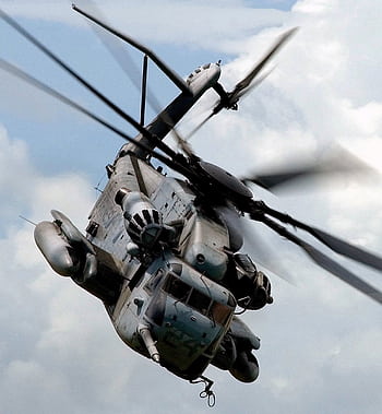 Military helicopter flying through the sky showcasing aviation power and versatility. HD phone wallpaper