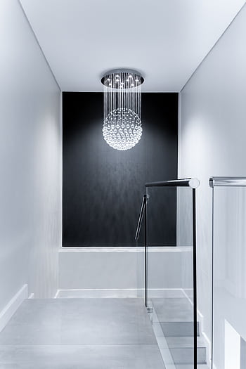Sleek contemporary hallway featuring a stunning glass chandelier and minimalist design. HD phone wallpaper
