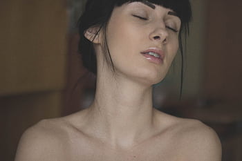 Close-up portrait of a woman with closed eyes, showcasing natural beauty and elegance. HD wallpaper