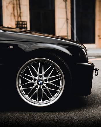 Close-up of a luxury sports car wheel with shiny chrome alloy rim in an urban setting. HD phone wallpaper