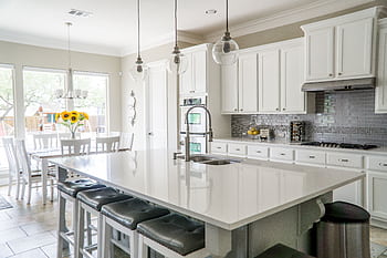 Spacious modern kitchen with white cabinets and island in natural light. HD wallpaper