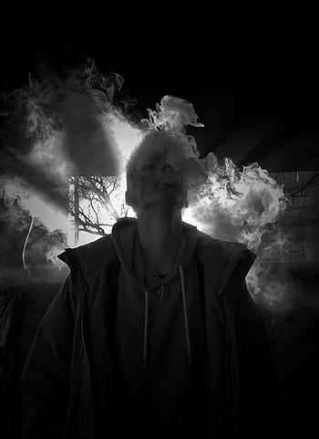 A striking monochrome portrait capturing a person enveloped in smoke, creating an eerie and dramatic silhouette effect. HD phone wallpaper