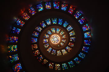 Captivating spiral stained glass art with vibrant colors forming a dramatic eye-catching pattern. HD wallpaper
