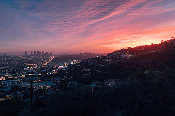 Capture of the vibrant Los Angeles skyline under a dramatic sunset sky. HD wallpaper