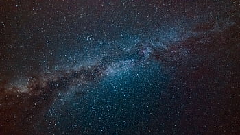 A stunning view of the Milky Way galaxy filling the night sky, showcasing countless stars. HD wallpaper
