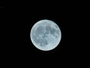 A bright full moon illuminating the dark night sky, capturing the lunar surface details. HD wallpaper