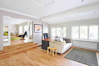 Spacious and bright modern living room with wooden floors and stylish furniture. HD wallpaper