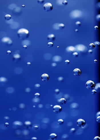 Captivating of water bubbles in vibrant blue, showcasing texture and clarity. HD phone wallpaper