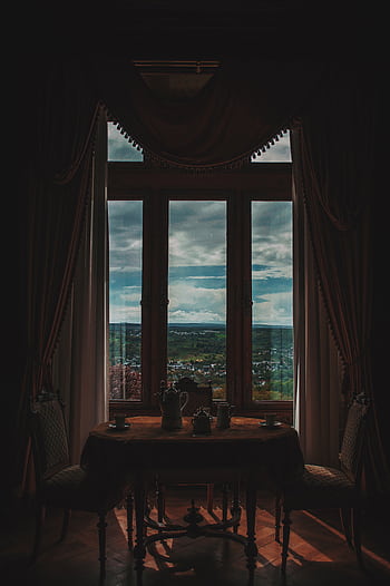 Cozy interior with a window view over a que landscape, featuring elegant furniture. HD phone wallpaper
