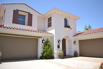 Bright suburban home with classic architecture and landscaped garden, ideal for real estate listings. HD wallpaper