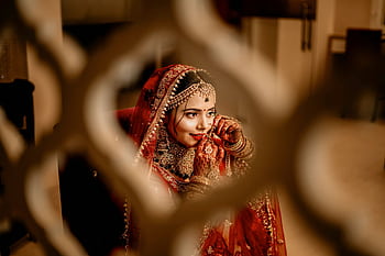 A beautiful Indian bride in Chandigarh adorned in traditional bridal wear and jewelry. HD wallpaper