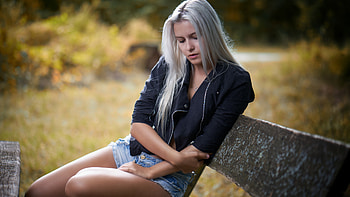 White Hair Girl Model Is Sitting On Wood Bench Wearing Black Overcoat Blue Jean Shorts In Blur Background Girls HD wallpaper