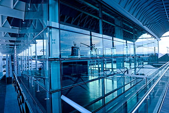 Contemporary glass building exterior reflecting urban landscape in Auckland, New Zealand. HD wallpaper