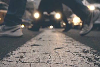 Blurred view of pedestrians crossing at night in New York City, capturing urban motion and energy. HD wallpaper