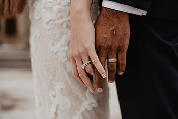 Two clasped hands showing wedding rings symbolizing unity and love in Syracuse. HD wallpaper