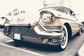 A classic Cadillac captured in motion, showcasing its vintage charm and sleek design. HD wallpaper