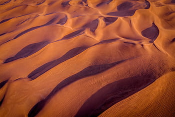 Stunning aerial graph showcasing expansive sand dunes at sunset. HD wallpaper