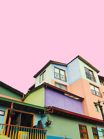 Colorful buildings in Guatapé showcase vibrant architectural design against a pastel sky. HD phone wallpaper