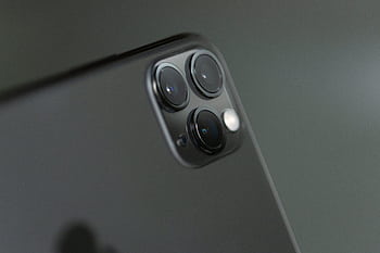 Detailed close-up of triple-camera system on a smart, showcasing modern technology. HD wallpaper