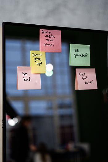 Colorful sticky notes with motivational quotes on a mirror indoors. HD phone wallpaper