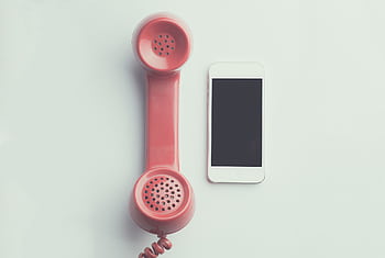 Comparison of a vintage pink tele receiver and a modern smart on a simple backdrop. HD wallpaper