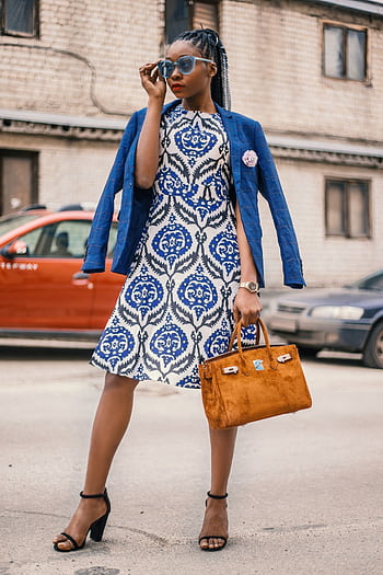 Stylish woman in a blue blazer and dress posing confidently outdoors. HD phone wallpaper