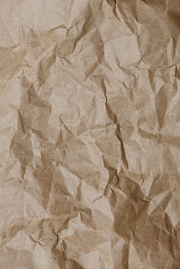 Close-up of crumpled brown paper texture ideal for backgrounds and design projects. HD phone wallpaper