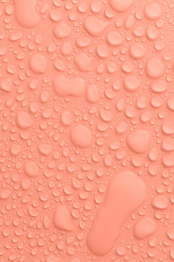 Close-up of water droplets on a peach background, showcasing texture and color. HD phone wallpaper