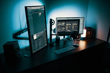 A contemporary office desk featuring a dual monitor setup with stylish lighting, ideal for tech enthusiasts. HD wallpaper