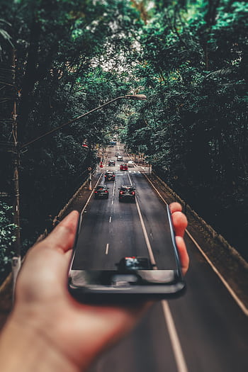 Creative blend of technology and nature with smart framing a bustling road through forest. HD phone wallpaper