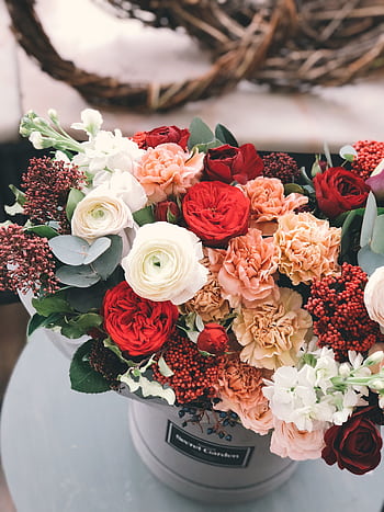 A beautifully arranged bouquet of colorful roses and carnations in a decorative vase. HD phone wallpaper