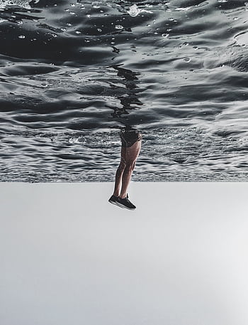 A surreal of legs appearing to walk on the ocean surface, creating a dreamlike effect. HD phone wallpaper
