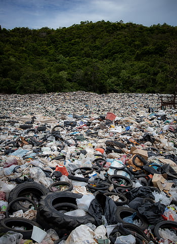 Expansive view of a landfill filled with tires and rubbish in Pattaya, Thailand. HD phone wallpaper
