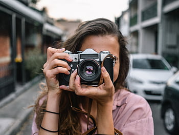 A woman captures a street scene with a classic camera in Surry Hills, Australia. HD wallpaper