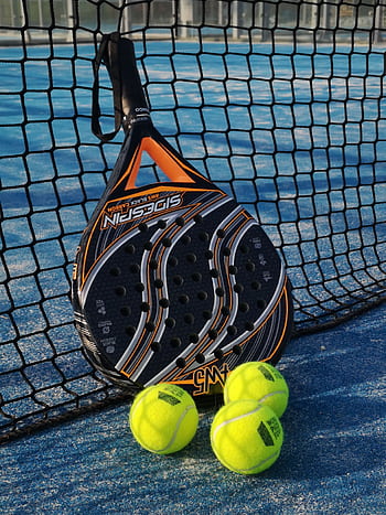 Close-up of padel racket and balls on an outdoor court with net in bright sunlight. HD phone wallpaper