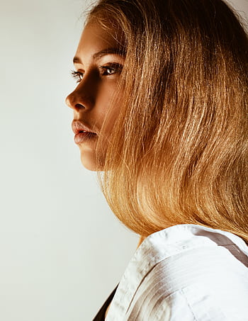 Elegant side profile portrait of a young woman with blonde hair in natural lighting. HD phone wallpaper