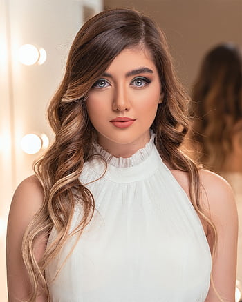 Stunning portrait of a woman with wavy brown hair and elegant makeup, styled for a sophisticated look. HD phone wallpaper