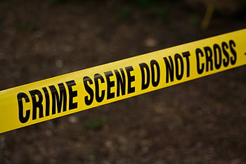 Close-up of crime scene tape with 'Do Not Cross' text, outdoors setting. HD wallpaper