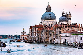 Captivating view of the Grand Canal in Venice with the iconic Santa Maria della Salute basilica and bustling waterways. HD wallpaper