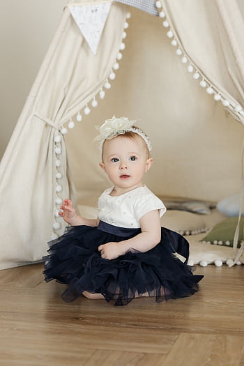 Cute baby sits in a navy tutu inside a tent, perfectly capturing innocence and charm. HD phone wallpaper